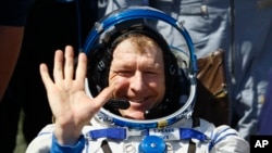 Member of the International Space Station (ISS) crew Britain's Tim Peake waves after landing near the town of Dzhezkazgan, Kazakhstan, Saturday, June 18, 2016.