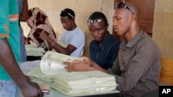 Electoral voter cards are distributed in the capital Bujumbura, Burundi, Thursday, June 4, 2015. 