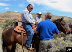 Interior Secretary Ryan Zinke, right, talks with two men on horses, May 8, 2017, at the Butler Wash trailhead within Bears Ears National Monument near Blanding, Utah.