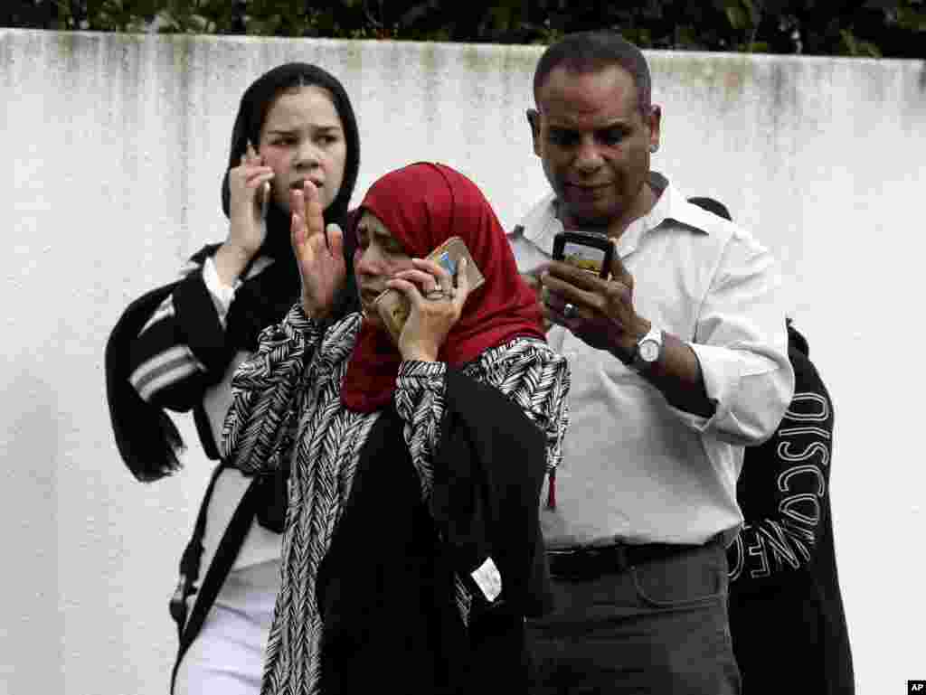 People wait outside a mosque in central Christchurch, New Zealand, March 15, 2019. 