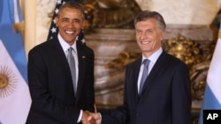 U.S. President Barack Obama shakes hands with Argentina's President Mauricio Macri at the government house in Buenos Aires, Argentina, March 23, 2016.