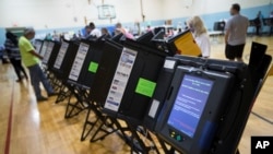 FILE - Electronic voting machines in Columbus, Ohio, Nov. 3, 2015. Democrats and Republicans compete in primaries and caucuses in at least 11 states and one U.S. territory on Tuesday.