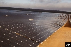 FILE - A photovoltaic solar park situated on the outskirts of the coastal town of Lamberts Bay, South Africa.