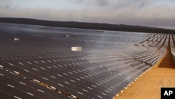 FILE - A photovoltaic solar park situated on the outskirts of the coastal town of Lamberts Bay, South Africa on March. 29, 2016. Developer Senergy PV SA, says they will install 96,000 gleaming solar panels from China, injecting up to 30 megawatts into the grid.