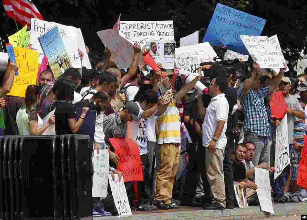Demonstrators ask for help for Yazidi people who are stranded by violence in northern Iraq, across from the White House in Washington, DC, Aug. 7, 2014.