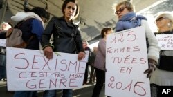 FILE - Women hold placards reading "Sexism is not my gender,“ left, and “125 women killed in 2016" during a rally protesting sexual abuse and harassment, in Marseille, southern France, Oct. 29, 2017.