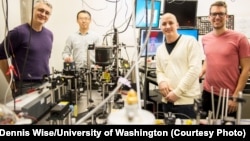 This instrument built by UW engineers (from left) Peter Pauzauskie, Xuezhe Zhou, Bennett Smith, Matthew Crane and Paden Roder (unpictured) used infrared laser light to refrigerate liquids for the first time.Dennis Wise/University of Washington