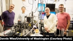 This instrument built by UW engineers (from left) Peter Pauzauskie, Xuezhe Zhou, Bennett Smith, Matthew Crane and Paden Roder (unpictured) used infrared laser light to refrigerate liquids for the first time.