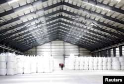 FILE - A storage unit is seen at an industrial plant in Llipi on the salt lake of Uyuni, Potosi, Bolivia, Oct. 7, 2018.