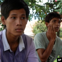 Buot Panha, left, who jumped off the bridge to safety, and his friend Ra, right, both of whom survived the stampede.