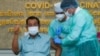 Cambodian Prime Minister Hun Sen gestures as he receives the AstraZeneca vaccine during a vaccination campaign against the Covid-19 coronavirus at Calmette hospital in Phnom Penh, Cambodia, on March 4, 2021. (Photo by Kok Ky / AFP) 