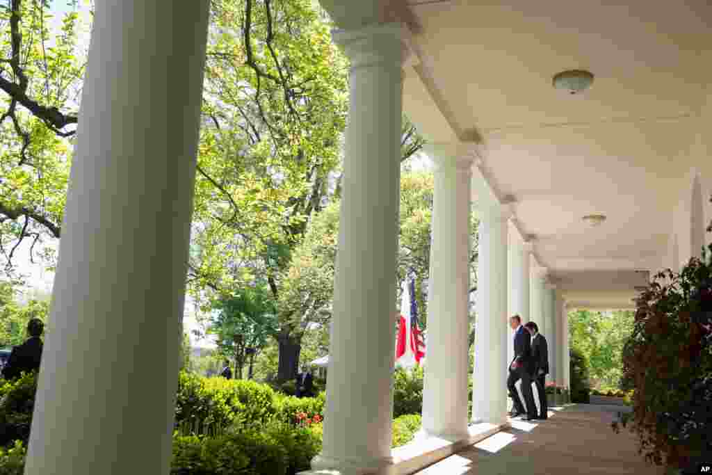 President Barack Obama and Japanese Prime Minister Shinzo Abe walk to the Rose Garden of the White House in Washington for a joint news conference.