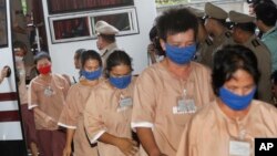 Female suspects allegedly involved in human trafficking of Rohingya migrants file into the Criminal Court in Bangkok, Thailand, Nov. 10, 2015.