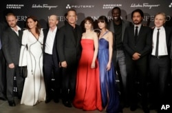 FILE - From left, Ben Foster, Sidse Babett Knudsen, director Ron Howard, Tom Hanks, Ana Ularu, Felicity Jones, Omar Sy, Irrfan Khan, and writer Dan Brown, pose at the premiere of the movie 'Inferno,' based on a novel by Dan Brown, at the opera house in Florence, Italy.