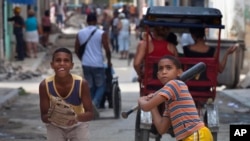 FILE -Youths play baseball in the streets of Old Havana, Cuba, June 11, 2013.