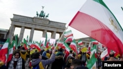 People demonstrate in support of protests across Iran, Jan. 6, 2018, in front of the Brandenburg Gate in Berlin.
