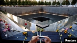 A visitor photographs the National September 11 Memorial and Museum on the 15th anniversary of the 9/11 attacks in New York, Sept. 11, 2016. The Minnesota defendant said he has been angry at Muslims since the attacks. 