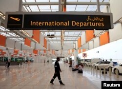 FILE - A worker walks through the departure area of the newly built Islamabad International Airport, during a media tour ahead of its official opening, Pakistan, April 18, 2018.