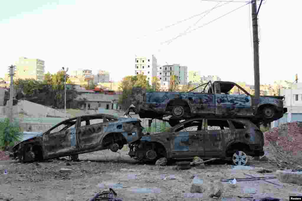 Damaged cars are seen piled up to be used as cover from snipers in Ashrafieh, Aleppo, August 5, 2013. 