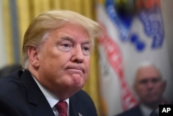 FILE - President Donald Trump holds a meeting with Chinese Vice Premier Liu He in the Oval Office of the White House in Washington, Jan. 31, 2019.