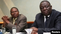 Zimbabwe Movement For Democratic Change (MDC) leader Morgan Tsvangirai (R) and Simba Makoni (L) of the Mavambo/Dawan/Kusile (MDK) party address a news conference in Harare, July 8, 2013.