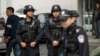 Armed policemen stand guard near the site of an explosion in Urumqi, northwest China's Xinjiang region, May 22, 2014.