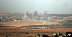 FILE - Smoke billows from the Syrian-Turkish border, Aug. 24, 2016.