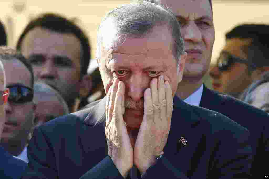 Turkish President Recep Tayyip Erdogan wipes his tears during the funeral of Mustafa Cambaz, Erol and Abdullah Olcak, killed Friday while protesting the attempted coup, in Istanbul.