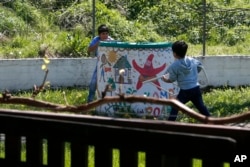 Fatima Bakhshi's children Ahmed, right, and Shoaib play in a small care home in the village of Doljevac, in southern Serbia, April 10, 2017.