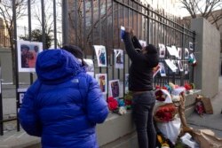 Volunteers with the "Wall of Hope Foundation" build a memorial wall for the victims of New York City's deadliest fire in three decades, in the Bronx borough of New York, Jan. 12, 2022.