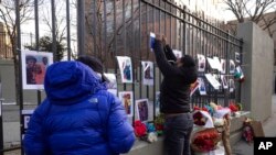 Volunteers with the 'Wall of Hope Foundation' build a memorial wall for the victims of New York City's deadliest fire in three decades, in the Bronx borough of New York, Jan. 12, 2022.
