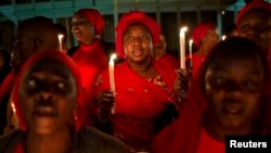 People hold candles and pray in Abuja, the capital, during a vigil calling for the release of Nigerian schoolgirls abducted in the remote village of Chibok, Nigeria, May 15, 2014.
