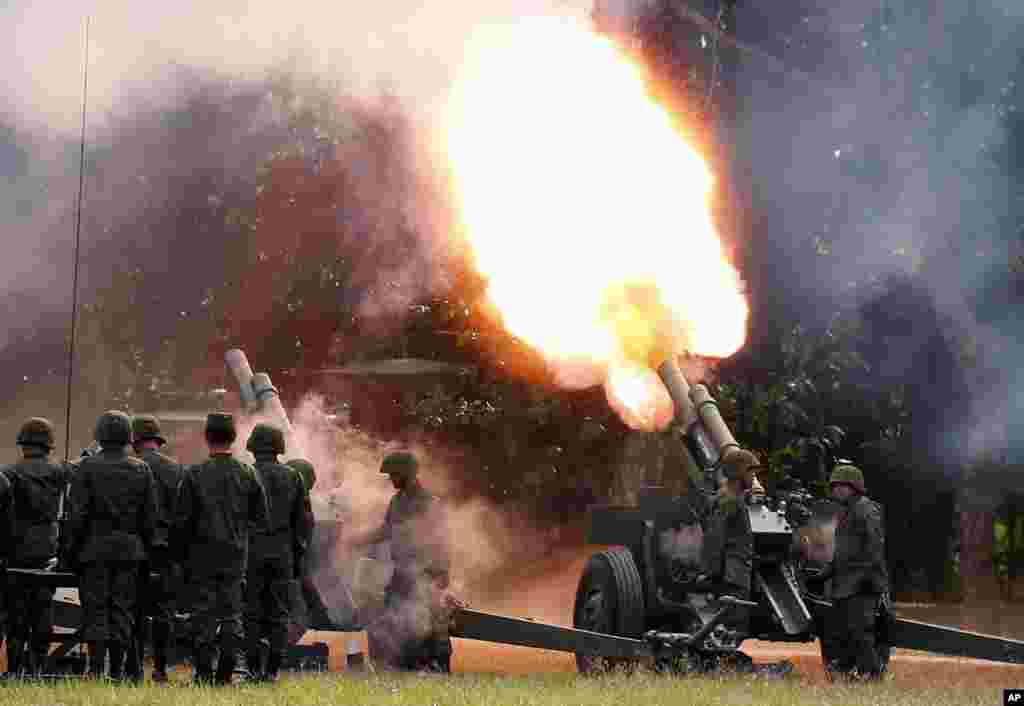 Philippine troops fire cannons to give President Rodrigo Duterte a 21-gun salute during the 121st anniversary celebration of the Philippine Army, in Taguig city, east of Manila.