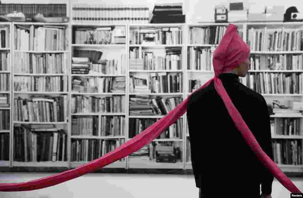 A performer of artist James Lee Byers&#39; artwork &quot;Ten in a Hat&quot;, wearing a copy of the original 1968 version, is pictured at the Frieze Art Fair in London. 