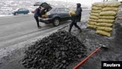 People load coal into a car in Ulaanbaatar, Mongolia as the wave of extreme cold hits the country, Dec. 22, 2016. 