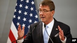 FILE - U.S. Defense Secretary Ash Carter, pictured at a Paris news conference in January, is in Abu Dhabi, a stop on a Mideast tour that will focus on the fight against Islamic State.