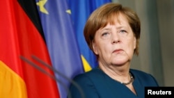 FILE - German Chancellor Angela Merkel and Ukrainian President Petro Poroshenko adress the media after a meeting at the German government guesthouse Meseberg Palace in Meseberg, May 20, 2017. 