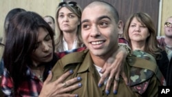 Israeli soldier Elor Azaria is embraced by his mother at the start of his sentencing hearing in Tel Aviv, Israel, Feb. 21, 2017. 