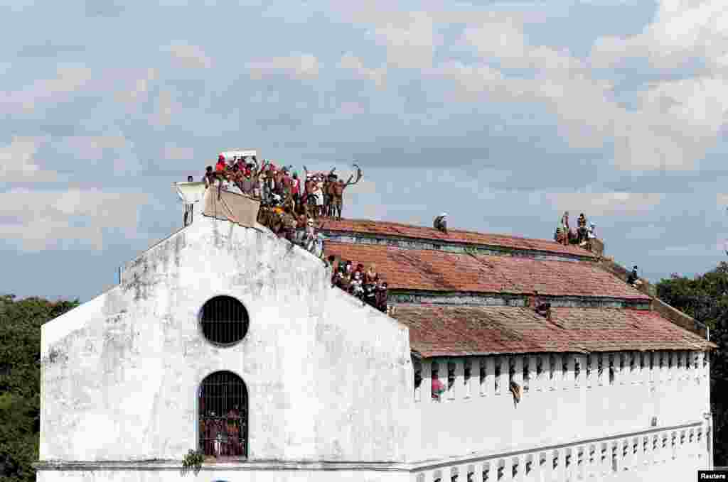 Inmates protest on the top of a prison building demanding to speed up their judicial process, after the number of COVID-19 cases increased in prisons in Colombo, Sri Lanka.