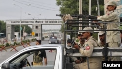 Paramilitary soldiers guard main entrance of air force base in Kamra, Punjab province, August 16, 2012. 