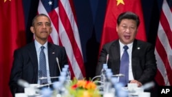 FILE - President Barack Obama, left, meets with Chinese President Xi Jinping.