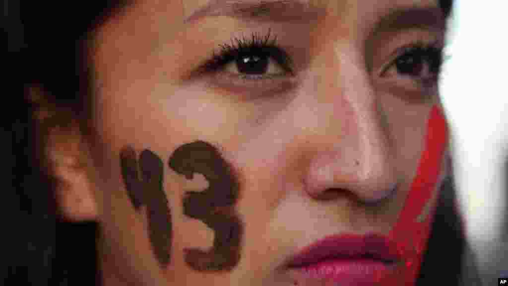 A female demonstrator with the number 43 painted on her face marches in protest for the disappearance of 43 students in the state of Guerrero, in Mexico City, Nov. 5, 2014. 