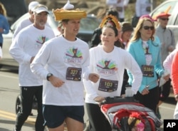 A runner with a hat shaped into a piece of pumpkin pie takes part in the 40th annual Turkey Trot to raise money for the Denver chapter of the United Way in south Denver on Thursday, Nov. 28, 2013.