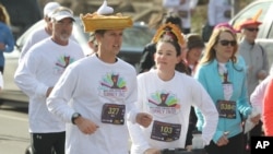 FILE - A runner with a hat shaped into a piece of pumpkin pie with whipped cream takes part in the 40th annual Turkey Trot to raise money for the Denver chapter of the United Way in south Denver on Thursday, Nov. 28, 2013. (AP Photo/David Zalubowski)
