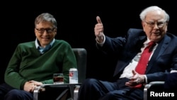 FILE - Bill Gates and Warren Buffett, at Columbia University in New York, Jan. 27, 2017. The two, once again, are the richest men according to Forbes. (REUTERS/Shannon Stapleton)