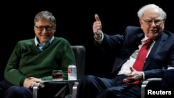 Warren Buffett, chairman and CEO of Berkshire Hathaway, speaks while Bill Gates looks on at Columbia University in New York, Jan. 27, 2017. 