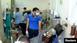 A woman affected by what activists say was a gas attack on the town of Telminnes, breathes through an oxygen mask at Bab al-Hawa hospital, where she was transferred to, close to the Turkish border, on April 21, 2014.(Amer Alfaj/Reuters)