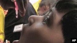 A child receives his oral polio vaccine.