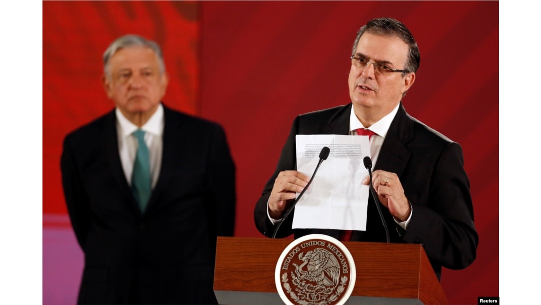 Mexico's Foreign Minister Marcelo Ebrard holds a document as Mexico's President Andres Manuel Lopez Obrador looks on during a news conference at the National Palace in Mexico City, Mexico, June 10, 2019.