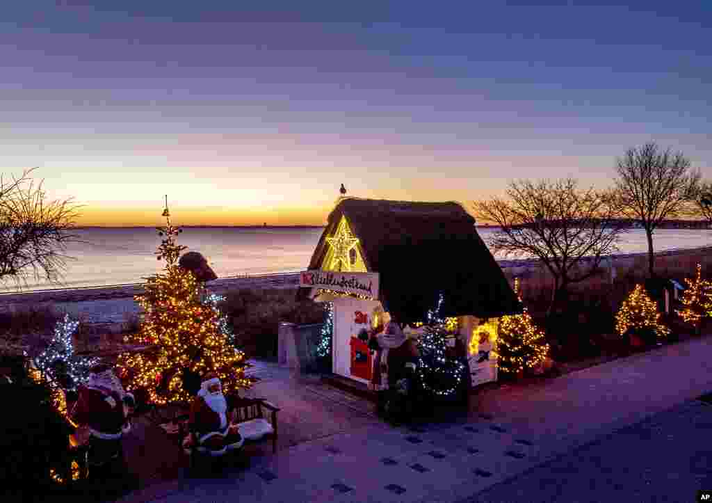 Christmas trees and Santa Clauses decorate the entrance to the beach in Haffkrug, northern Germany.